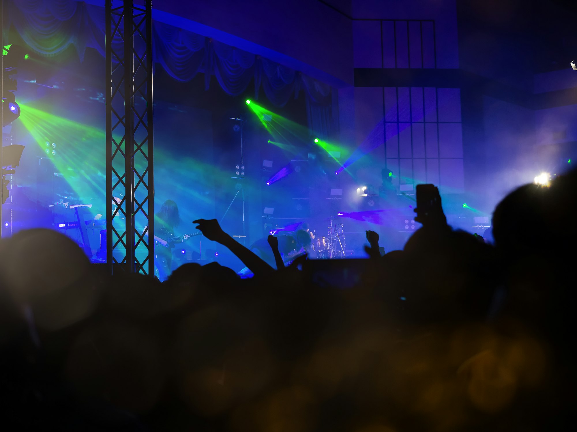 Cheering fans raising their hands on the beat in a free live concert in music festival.